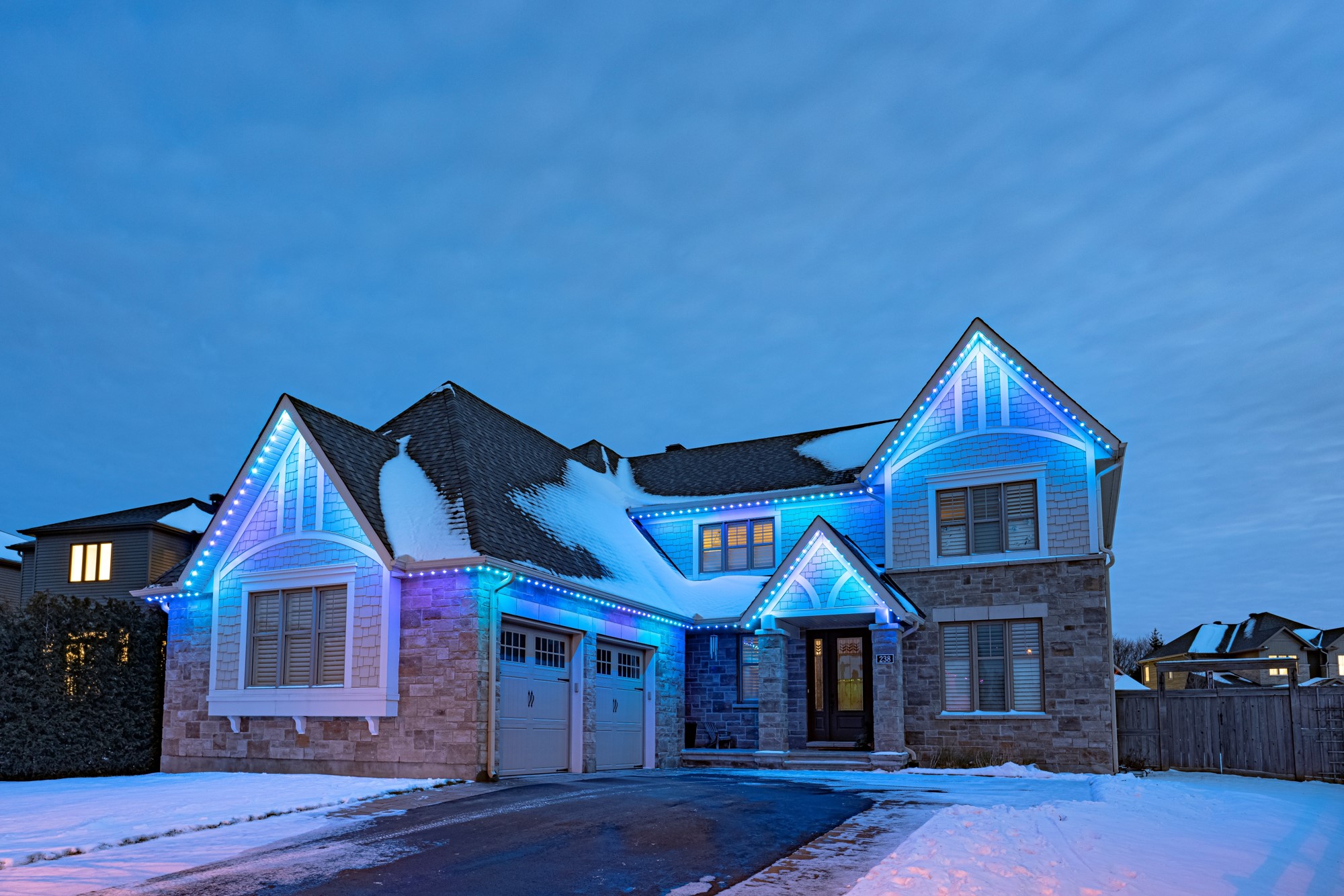 Permanent cool-blue and white winter 'frozen' lighting on a home at night