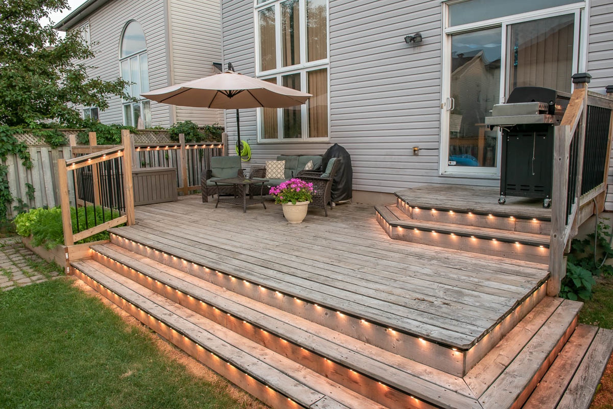 Permanent LED lighting on a deck and patio for evening ambiance