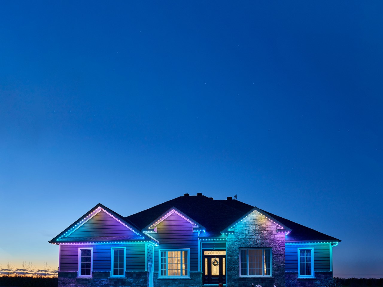 Permanent pastel Easter lighting on a home roofline in spring